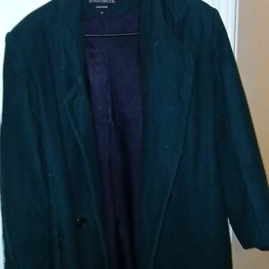 A Danny Brooks trench coat is a type of outerwear designed by the fashion brand